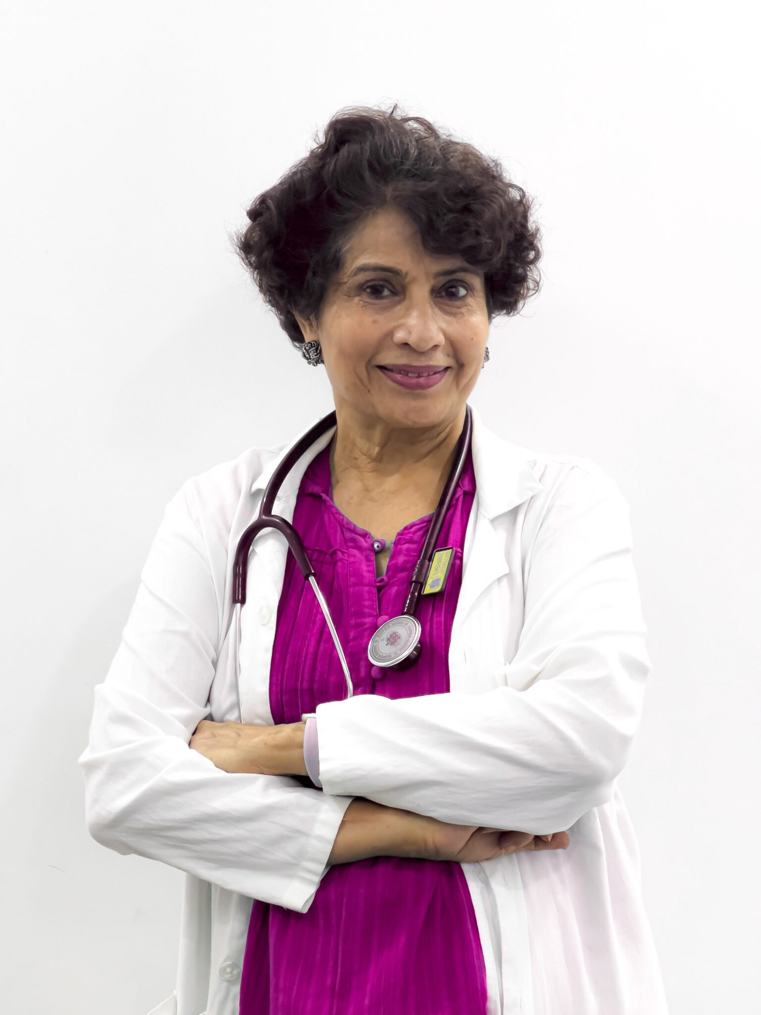 Dr. Malti Bhojwani, senior gynecologist and IVF specialist in Bhopal, sitting in clinic office and providing women’s healthcare services